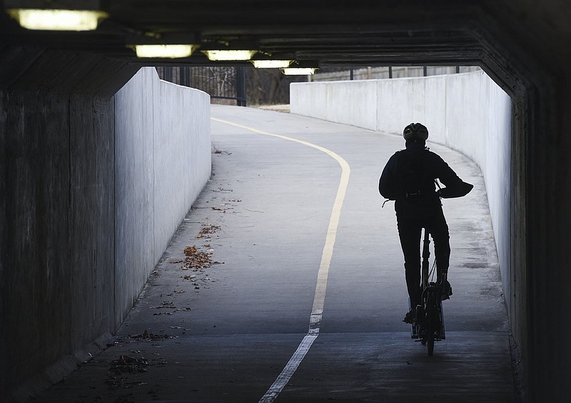 A rider passes through a tunnel, Saturday, January 16, 2021 along the Razorback Greenway in Bentonville. A group formed to make sure the Northwest Arkansas Razorback Greenway is safe and consistent along its entire 40-mile length got an initial assessment of the conditions and needs this week. Check out nwaonline.com/210117Daily/ for today's photo gallery. 
(NWA Democrat-Gazette/Charlie Kaijo)