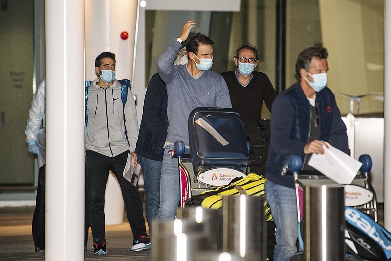 Spain’s Rafael Nadal, center, arrives at Adelaide Airport Thursday ahead of the Australian Open in Adelaide, Australia. Arriving players will serve a 14-day quarantine period ahead of the first Grand Slam tennis tournament that is set to get underway on Feb. 8 in Melbourne. - Photo by Morgan Sette/AAP Image via The Associated Press