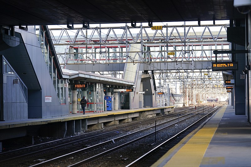 A man walks the Stamford Metro North train station Tuesday, Dec. 29, 2020, in Stamford, Conn.  With many New Yorkers moving to neighboring Connecticut during the pandemic, especially Fairfield County, it's becoming more challenging for people to find affordable homes to buy. (AP Photo/Frank Franklin II)