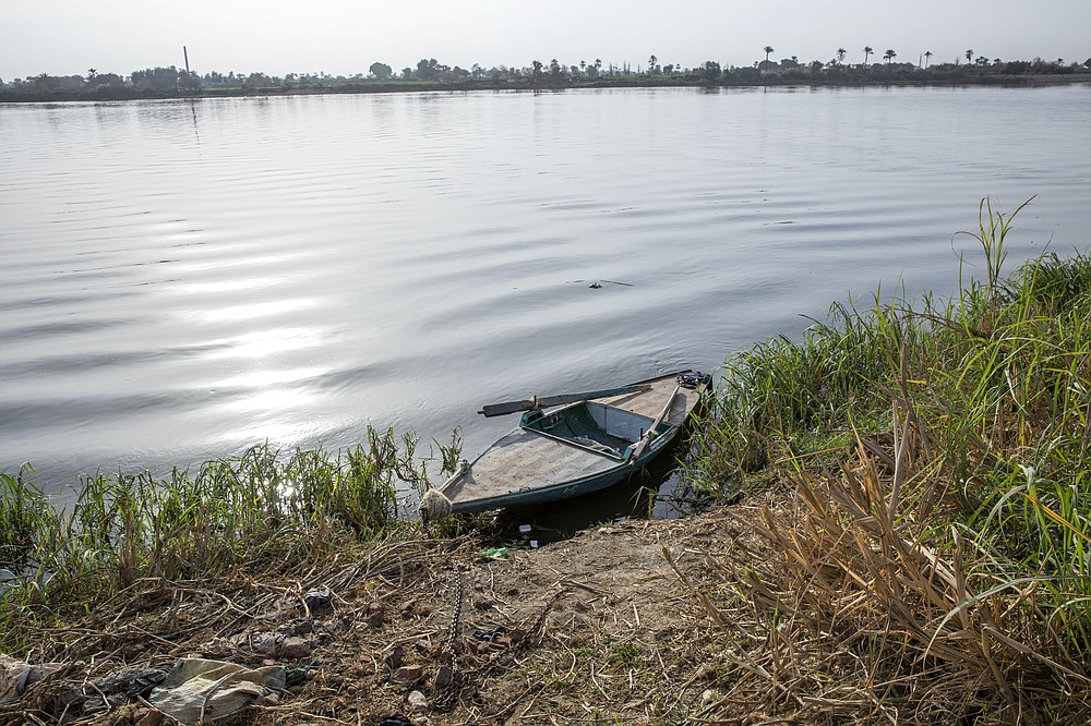 A boat is moored on the Nile river in Atfih town, Giza, Egypt, Tuesday, Jan. 12, 2021. Egyptians are marking 50 years since the inauguration of the Aswan High Dam, a massive feat of construction that has shaped the course of modern-day Egypt. It spared it from seasonal droughts and flooding, and generated electricity, but it also displaced members of the country's Nubian minority and had a lasting environmental impact on the region. (AP Photo/Nariman El-Mofty)