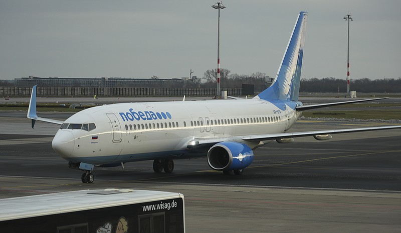 Boeing 737-800 of Pobeda Russian air company on which Alexei Navalny is expected to fly to Moscow, as it arrives to the Airport Berlin Brandenburg (BER) in Schoenefeld, near Berlin, Germany, Sunday, Jan. 17, 2021. Leading Kremlin critic Alexei Navalny plans to fly home to Russia on Sunday after recovering in Germany from his poisoning in August with a nerve agent. (AP Photo/Mstyslav Chernov)