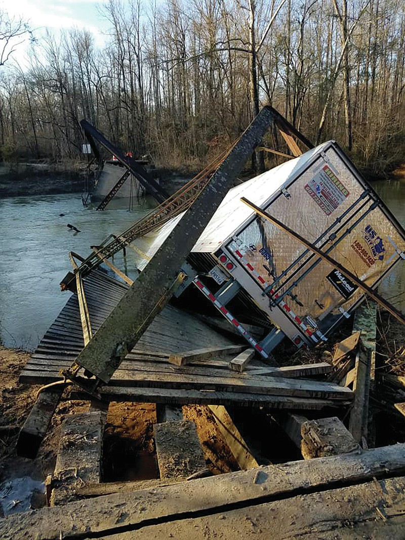 Special to the Arkansas Democrat-Gazette - 01-30 -2019 - An 18-wheeler sits atop the collapsed Dale Bend Bridge over the Petit Jean River near Ola in Yell County, January 30, 2019. Officials said the driver was following GPS directions when the bridge collapsed under the weight of the truck. The driver escaped unharmed.