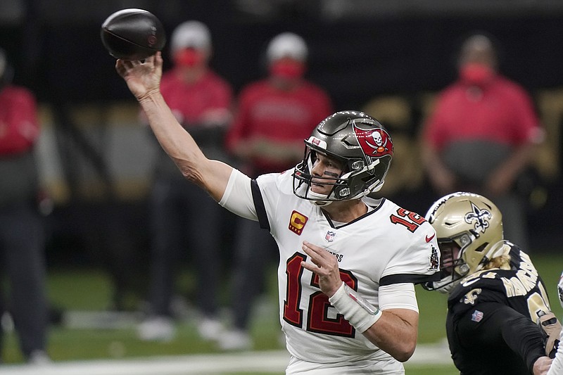 Tampa Bay Buccaneers quarterback Tom Brady (12) works against the New Orleans Saints during the first half of an NFL divisional round playoff football game, Sunday, Jan. 17, 2021, in New Orleans. (AP Photo/Brynn Anderson)