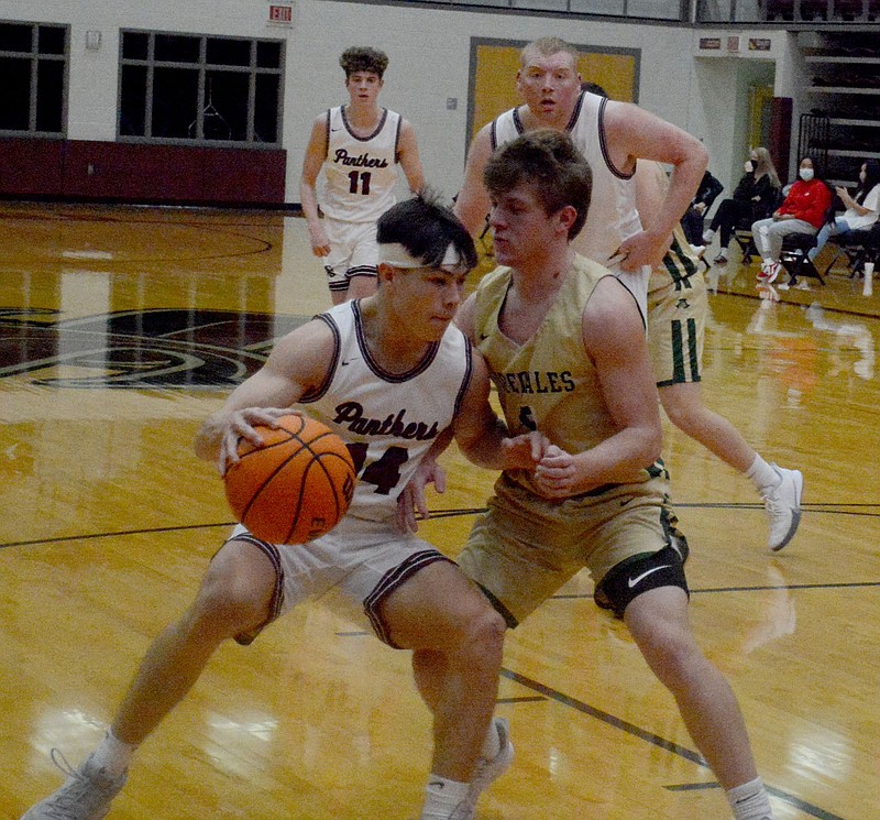 Graham Thomas/Herald-Leader
Siloam Springs senior Landon Ward, left, drives against Alma's Jacob Coursey during a game on Jan. 12. The Panthers are scheduled to play at Russellville on Friday.