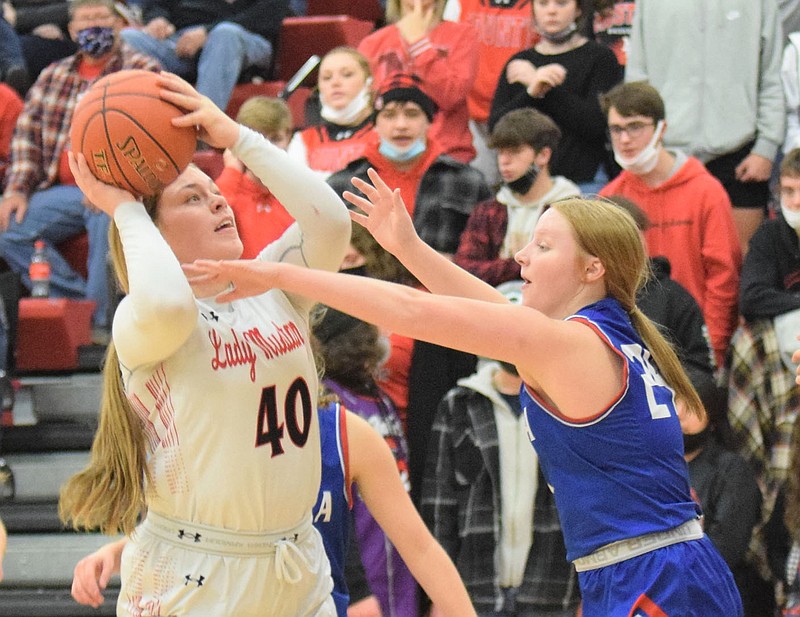 RICK PECK/SPECIAL TO MCDONALD COUNTY PRESS McDonald County's Adasyn Leach scores two of her 15 points over Seneca's Makayla  French during the Lady Mustangs' 65-56 homecoming win over the Lady Indians on Jan. 15 at MCHS.