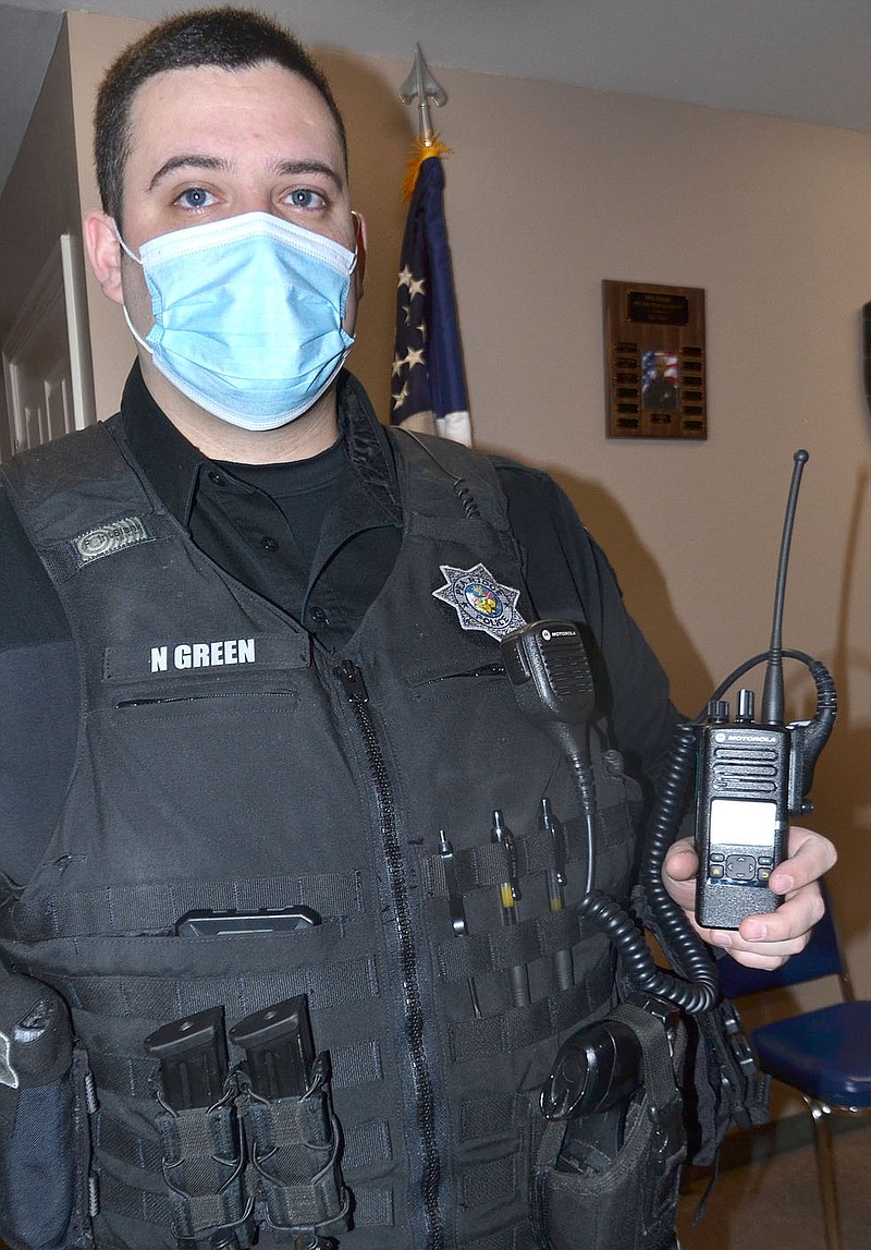 Pea Ridge Police Officer Nick Green shows one of the new AWIN police radios that will go in service this week.