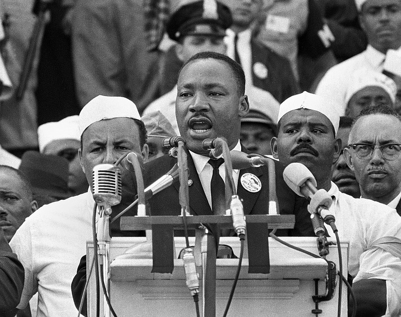 FILE - In this Aug. 28, 1963 file photo, Dr. Martin Luther King Jr., head of the Southern Christian Leadership Conference, addresses marchers during his "I Have a Dream" speech at the Lincoln Memorial in Washington. The annual celebration of the Martin Luther King Jr. holiday in his hometown in Atlanta is calling for renewed dedication to nonviolence following a turbulent year. The slain civil rights leader's daughter, the Rev. Bernice King, said in an online church service Monday, Jan. 18, 2021, that physical violence and hateful speech are “out of control” in the aftermath of a divisive election followed by a deadly siege on the U.S. Capitol in Washington by supporters of President Donald Trump. (AP Photo/File)