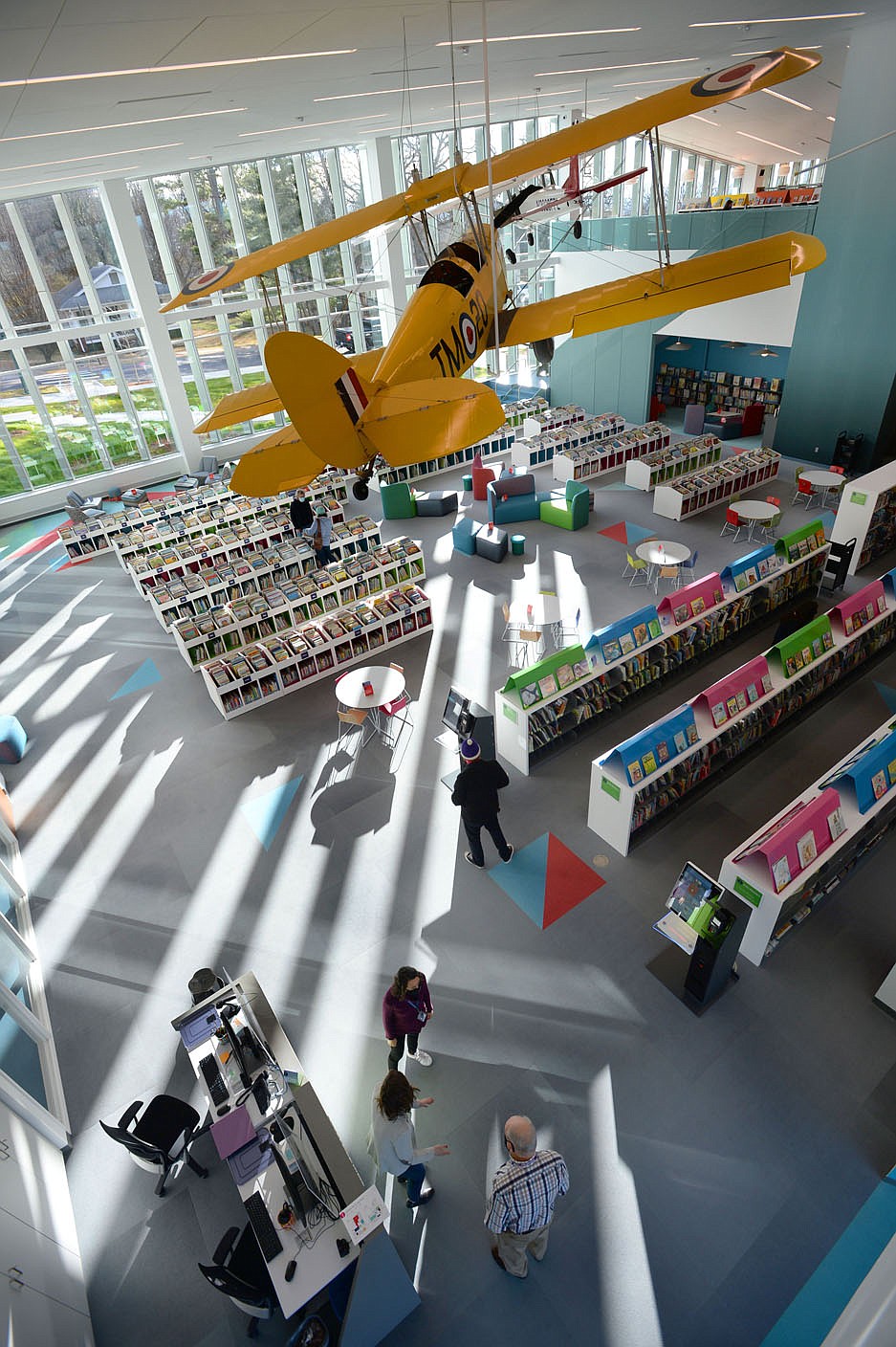 Aircraft hang Tuesday above the children’s section of the Fayetteville Public Library on the first day that the library has been open since its renovation and expansion. Voters in 2016 approved a property tax increase to help pay for the nearly $50 million expanded library's construction, which brings the building's size up to about 170,500 square feet. Library administrators opened to the public for the first time since late September, limiting the number of patrons to 200 at a time out of concern for the coronavirus pandemic. Visit nwaonline.com/210120Daily/ for today's photo gallery.
(NWA Democrat-Gazette/Andy Shupe)