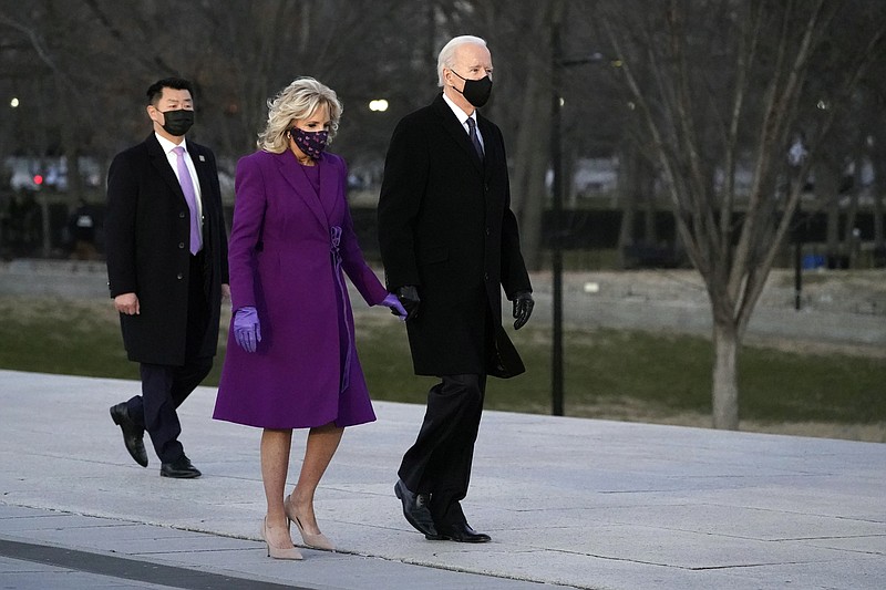 President-elect Joe Biden and his wife Jill arrive for a COVID-19 memorial, with lights placed around the Lincoln Memorial Reflecting Pool, Tuesday, Jan. 19, 2021, in Washington. (AP Photo/Alex Brandon)