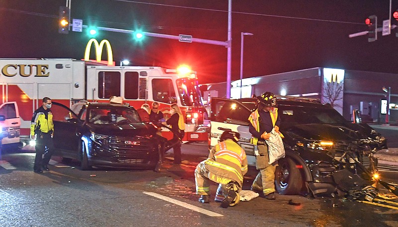 First responders work the scene of a two-vehicle collision involving a Hot Springs police patrol unit at the intersection of Crawford Street and Central Avenue Tuesday night. - Photo by Grace Brown of The Sentinel-Record