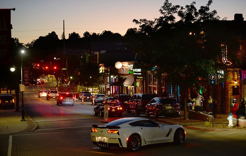 Traffic moves May 29, on Dickson Street in Fayetteville. The City Council voted to extend downtown's Outdoor Refreshment Area until at least April 30, 2024.
(File photo/NWA Democrat-Gazette/Andy Shupe)