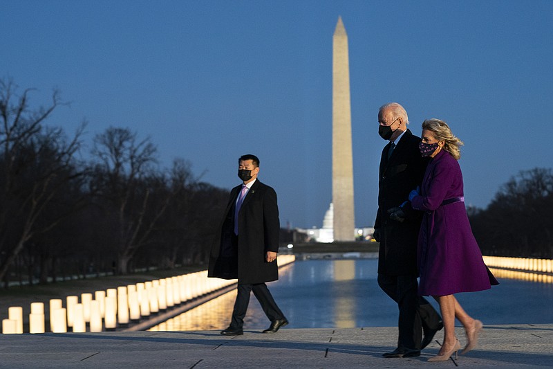 President-elect Joe Biden and his wife Jill Biden leave a COVID-19 memorial event at the Lincoln Memorial Reflecting Pool, Tuesday, Jan. 19, 2021, in Washington. (AP Photo/Evan Vucci)