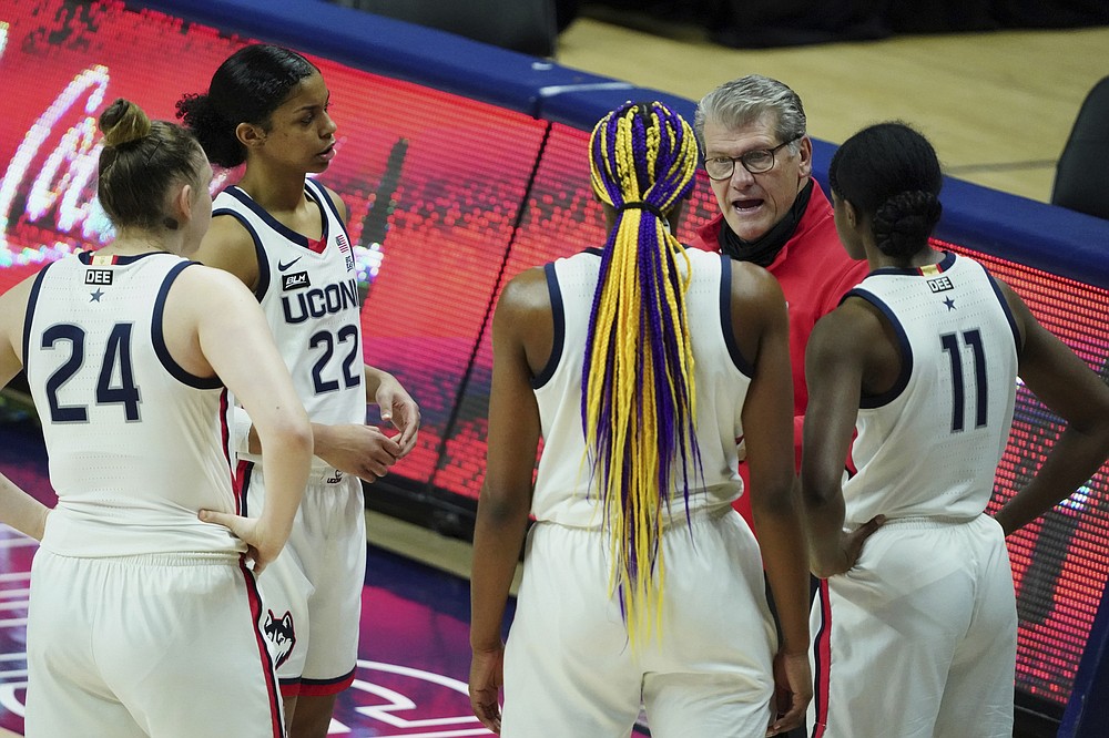 Connecticut head coach Geno Auriemma talks to his player during a break in the action in the second half of an NCAA college basketball game Tuesday, Jan. 19, 2021, in Storrs, Conn. (David Butler II/Pool Photo via AP)