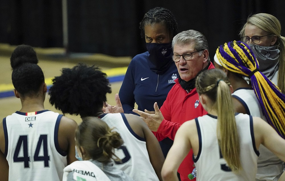 Connecticut head coach Geno Auriemma talks to his player during a break in the action in the second half of an NCAA college basketball game Tuesday, Jan. 19, 2021, in Storrs, Conn. (David Butler II/Pool Photo via AP)