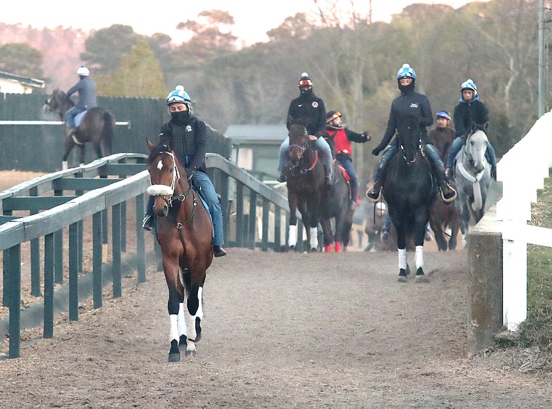 Horsemen exercise thoroughbred racehorses at Oaklawn Racing Casino Resort on Monday. - Photo by Richard Rasmussen of The Sentinel-Record