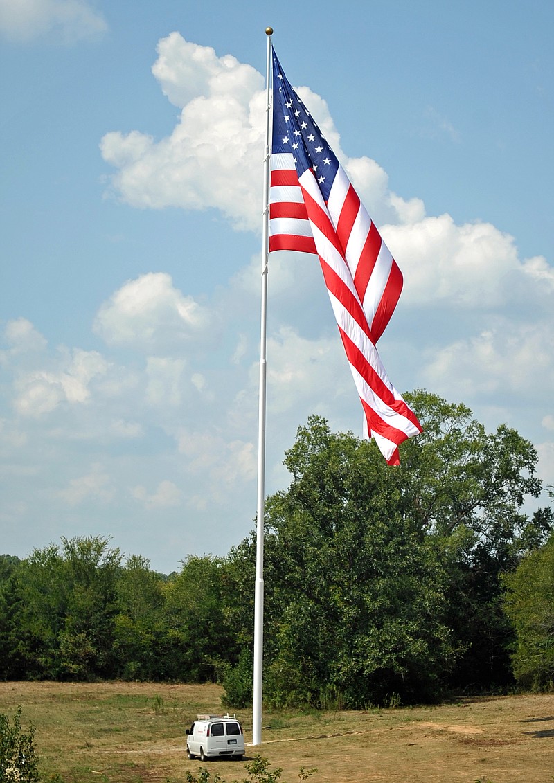Alliance Rubber's American flag is shown from the on-ramp from Carpenter Dam Road to the King Expressway in 2015. - File photo by The Sentinel-Record