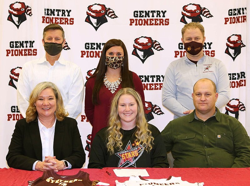 SUBMITTED
Emily Toland (center), a senior at Gentry High School, signed a letter of intent on Dec. 7, 2020, to play basketball with Stephen’s College in Columbia, Mo. She is pictured with her parents, Christie and Greg Toland, Gentry Coach Toby Tevebaugh (back, left), Gentry Coach Courtney Millsap, and Stephen’s College Coach Josh Steffen.