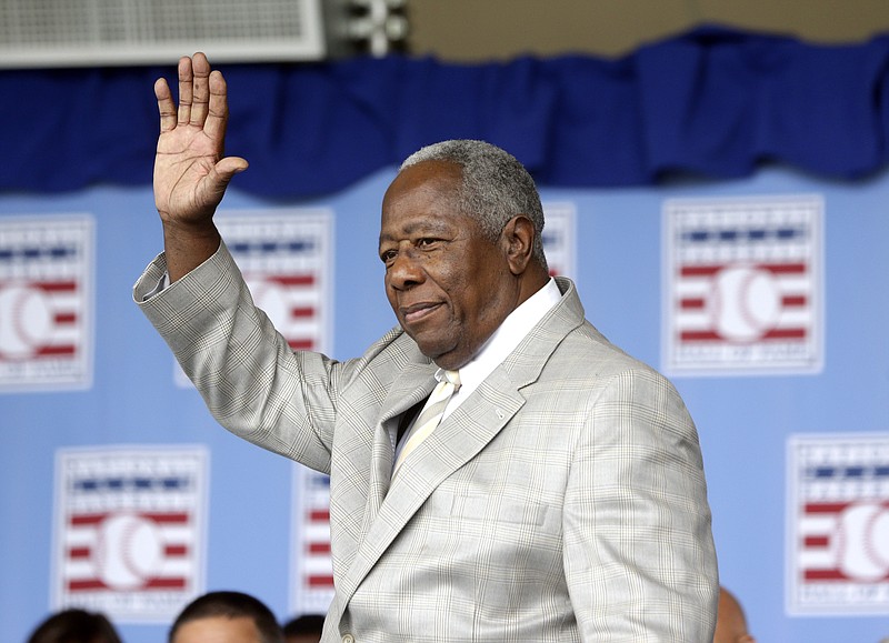 Hall of Famer Hank Aaron waves to the crowd during Baseball Hall of Fame induction ceremonies in Cooperstown, N.Y., on July 28, 2013. Aaron, who endured racist threats with stoic dignity during his pursuit of Babe Ruth but went on to break the career home run record in the pre-steroids era, died early Friday. He was 86. The Atlanta Braves said Aaron died peacefully in his sleep. No cause of death was given. - Photo by Mike Groll of The Associated Press