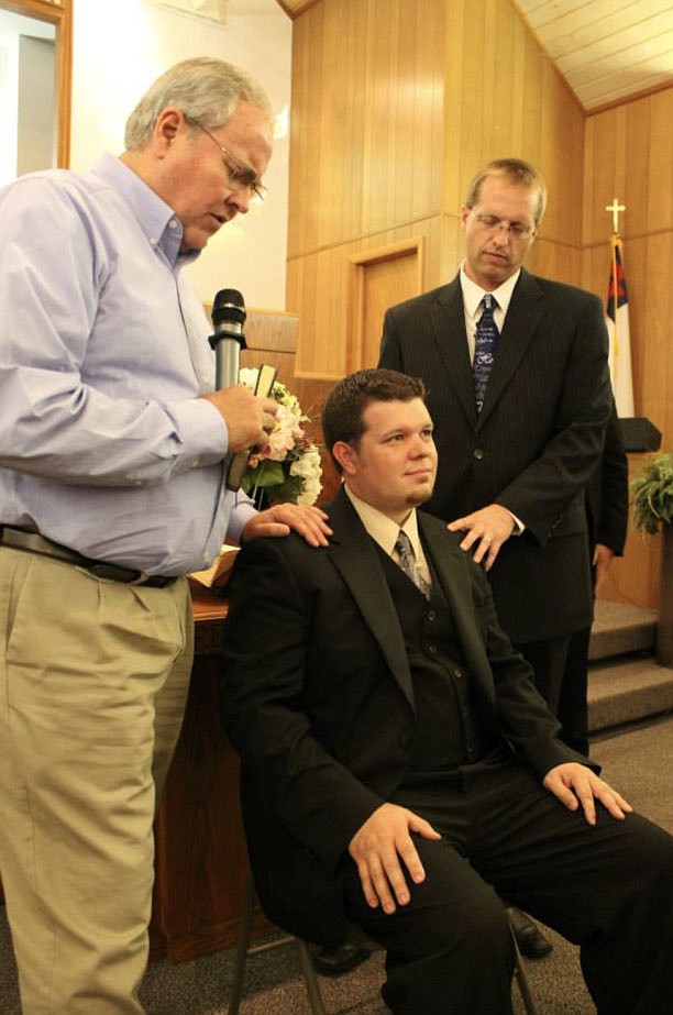 Barry Smith (left), former pastor of Farmington First Baptist Church, and Guy Durkee (right), a pastor at Oak Grove Baptist Church in Springdale, ordain James Bryan (middle) into Bethel Deaf Fellowship in 2014. Bryan has been a pastor for the fellowship for six years. (Courtesy Photo/Bethel Deaf Fellowship)