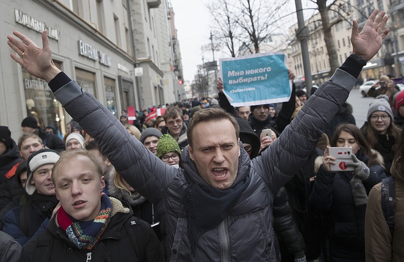FILE - In this Jan. 28, 2018, file photo, Russian opposition leader Alexei Navalny, centre, attends a rally in Moscow, Russia. Navalny is an anti-corruption campaigner and the Kremlin’s fiercest critic. He has outlasted many opposition figures and is undeterred by incessant attempts to stop his work. (AP Photo/Evgeny Feldman, File)