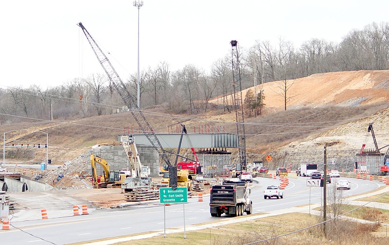 Keith Bryant/The Weekly Vista
Morning traffic rolls by as workers continue building the support structure for a bridge that will carry Interstate 49 onto the Bella Vista Bypass.