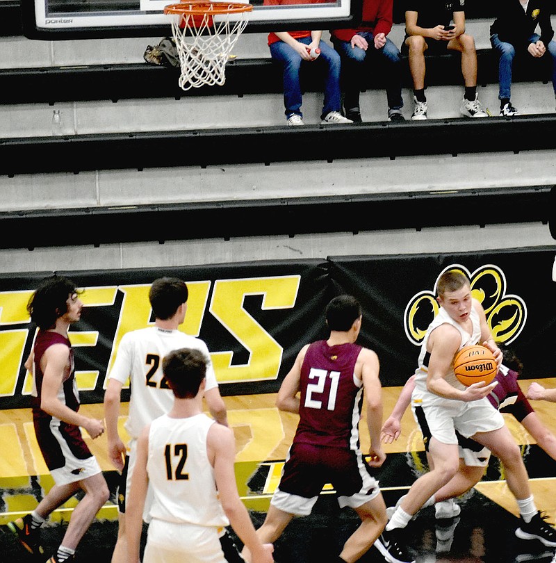 MARK HUMPHREY  ENTERPRISE-LEADER/Prairie Grove senior Knox Laird yanks down an offensive rebound and resets the offense during the Tigers' 45-43 barn-burner victory over Huntsville in 4A-1 Conference boys basketball play on Tuesday, Jan. 19.