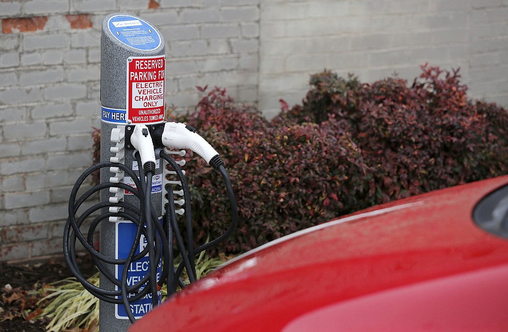 One of the electric car charging stations Thursday, January 21, 2021, installed in the parking lot of the Collier Drug Store on Dickson Street in Fayetteville. The city adopted regulations for businesses to follow when installing electric vehicle charging stations in their parking lots, such as minimum voltage, signs and fees. Check out nwaonline.com/210124Daily/ and nwadg.com/photos for a photo gallery.
(NWA Democrat-Gazette/David Gottschalk)