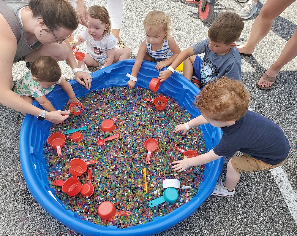 COURTESY PHOTO
Children play with water beads at a Macraroni Kids booth during an event in Northwest Arkansas. Kara Ault of Prairie Grove is the publisher for two Macaroni Kids websites, one for Fayetteville and one for Rogers-Bentonville.