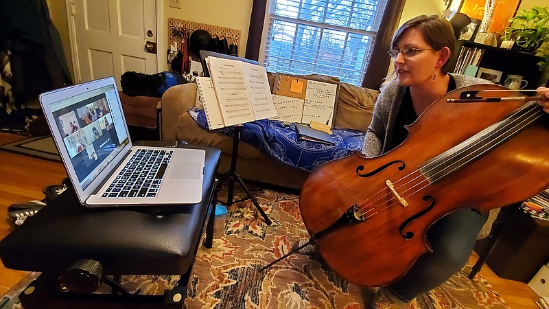 Cellist Joanna Klett says that solving problems posed by teaching cello during a pandemic — such as how to show the body of her cello to her online classes for the Arkansas Symphony Orchestra’s Sturgis Music Academy from her living room — has sharpened her skills. 
(Special to the Democrat-Gazette/Thomas McDonald)