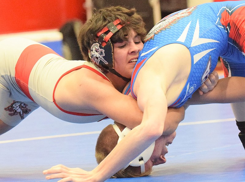 RICK PECK/SPECIAL TO MCDONALD COUNTY PRESS McDonald County's Blaine Ortiz pins Dalton Duley of Seneca to claim the championship of the 113-pound weight class at the Big 8 Conference Wrestling Tournament held on Jan. 22 at Seneca High School.