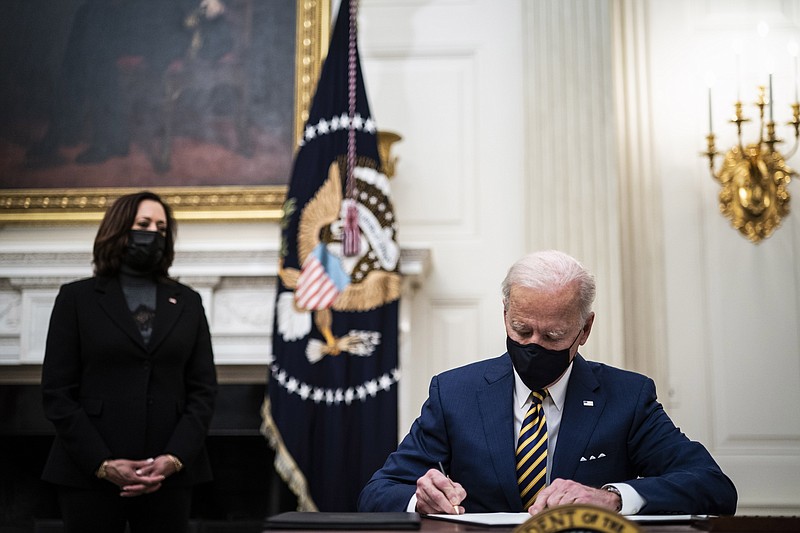 President Joe Biden signs executive orders at the White House on Friday, Jan 22, 2021. MUST CREDIT: Washington Post photo by Jabin Botsford