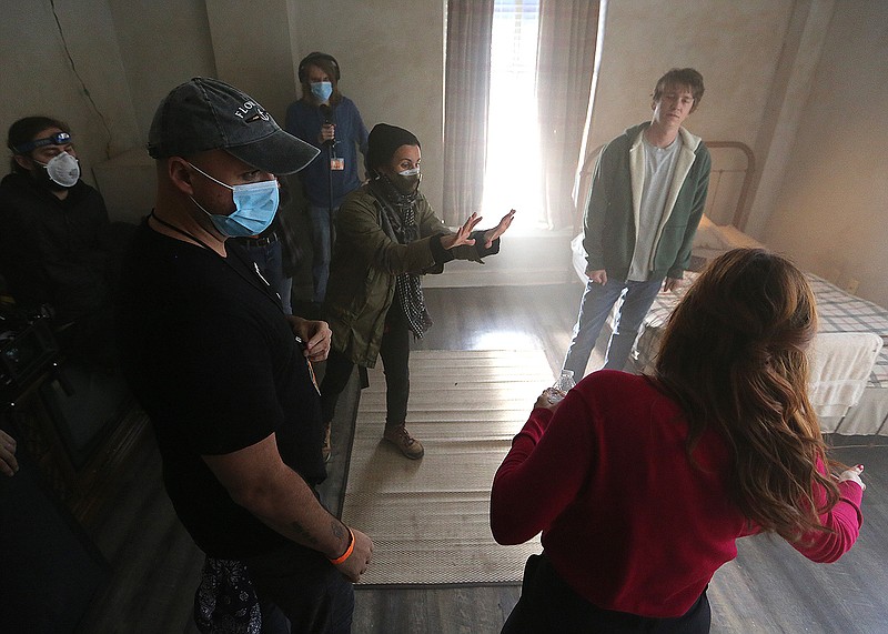 Director Adam Sigal (left) talks with actors, Scout Taylor-Compton (bottom right) and Thomas Mann (top right) and crew members about  a scene while shooting for a movie, "The Chariot" on Monday, Jan. 25, 2021, at the Hotel Frederica in Little Rock. The movie, described by Sigal as a "sci-fi dark comedy about reincarnation" is filming in various locations around Little Rock through Feb. 12.
(Arkansas Democrat-Gazette/Thomas Metthe)