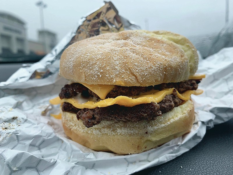 The Beast-style burger at Mr. Beast, as seen on a car dashboard in a Barnes & Noble parking lot in Virginia Beach, Va., in January 2021.  MrBeast is not a traditional restaurant, in the sense that you can’t actually go there. They also lack so much as a phone number. The burger spot instead has a shadowy and somewhat tenuous existence: findable only on delivery apps, and only if your address happens to fall within the delivery radius. (Matthew Korfhage/The Virginian-Pilot via AP)