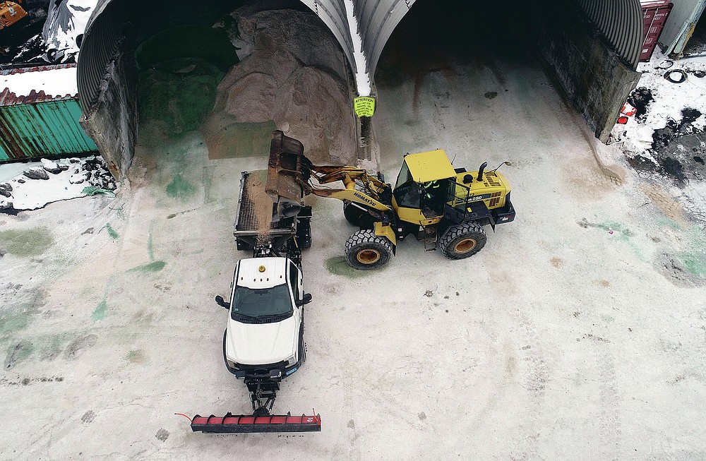 Mike LaCasse fills plow trucks with salt as a winter storm approaches, Tuesday, Jan. 26, 2021, in Pittsfield, Mass. (Ben Garver/The Berkshire Eagle via AP)