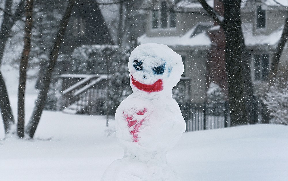 A snowman stands in a yard in Lake Zurich, Ill., during a winter storm, Tuesday, Jan. 26. 2021. (Paul Valade/Daily Herald via AP)
