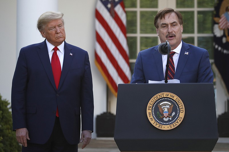 FILE - In this March 30, 2020, file photo, My Pillow CEO Mike Lindell speaks as President Donald Trump listens during a briefing about the coronavirus in the Rose Garden of the White House, in Washington. Twitter has permanently banned Lindell’s Twitter account after he continually perpetuated the baseless claim that Donald Trump won the 2020 U.S. presidential election. (AP Photo/Alex Brandon, File)