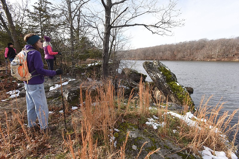 Hikers and mountain bikers can circle Lincoln Lake on the main trail and expore some side-trail loops. Sheila Ross (from left), Karen Mowry and Carol Taylor take in the scenery on Dec. 18 2020 from a high point on the trail.
(NWA Democrat-Gazette/Flip Putthoff)