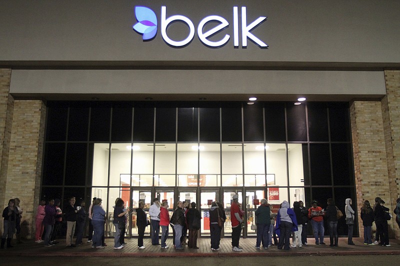 FILE - In this Nov. 25, 2011, file photo, shoppers line up outside a Belk store in Vicksburg, Miss., early in the morning for their Black Friday sales. Belk, the North Carolina-based department store chain which has catered to generations of shoppers for nearly 190 years, announced Tuesday, Jan. 26, 2021, that it will file for Chapter 11 bankruptcy. (Eli Baylis/The Vicksburg Post via AP)