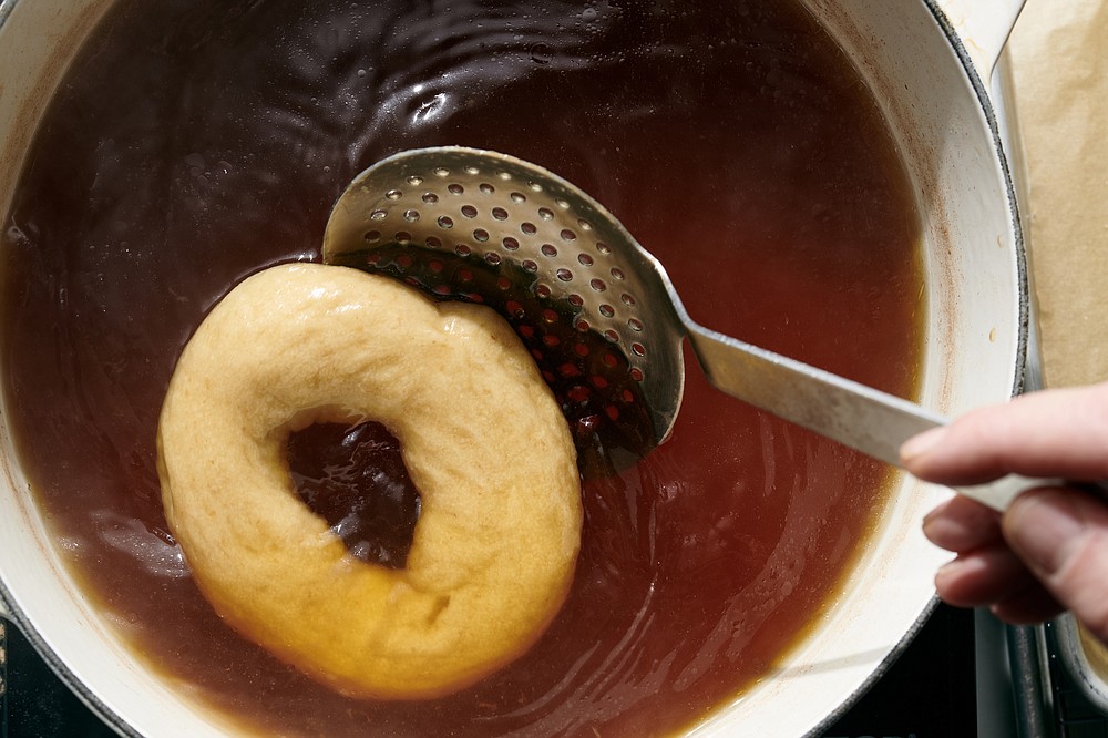 Boiling bagel dough before baking is crucial for proper bagel texture. (The New York Times/David Malosh)