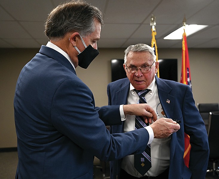 Congressman French Hill, left, removes a lavalier mic from the lapel of retired Master Sergeant Robert Davis after a short ceremony where Congressman Hill presented the retired Master Sergeant with the Vietnam Service Medal and the Republic of Vietnam Gallantry Cross, two medals that he should have received more than 40 years ago, on Tuesday, Jan. 26, 2021.

(Arkansas Democrat-Gazette/Stephen Swofford)