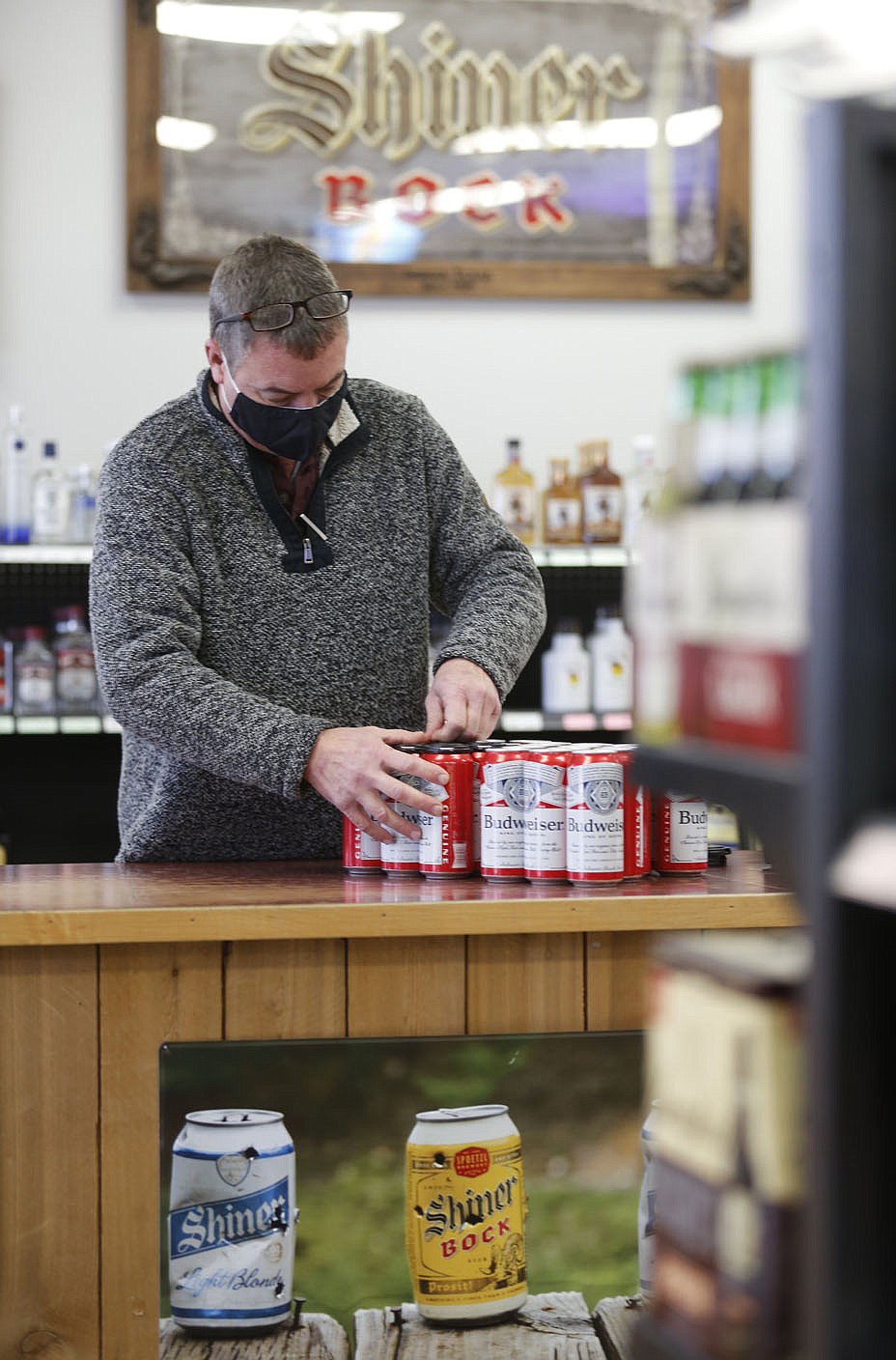 Charles Jech builds Tuesday, January 26, 2021, six packs of beer inside C and J Liquor located at 129 Fowler St., Suite A in Gentry. A special election on Feb. 9 will determine whether to authorize the sale of alcoholic beverages for off-premises consumption on Sundays between the hours of 10 a.m. and midnight within the city of Gentry. The City Council on Sept. 8 voted to add the ballot initiative to the Nov. 3 general election following a petition by Charles and Jerah Jech to have the initiative added to the ballot. The measure was submitted too late for the Nov. 3 ballot and was moved to December. When that wouldn’t work, the election was scheduled for Feb. 9. Check out nwadg.com/photos for a photo gallery.
(NWA Democrat-Gazette/David Gottschalk)