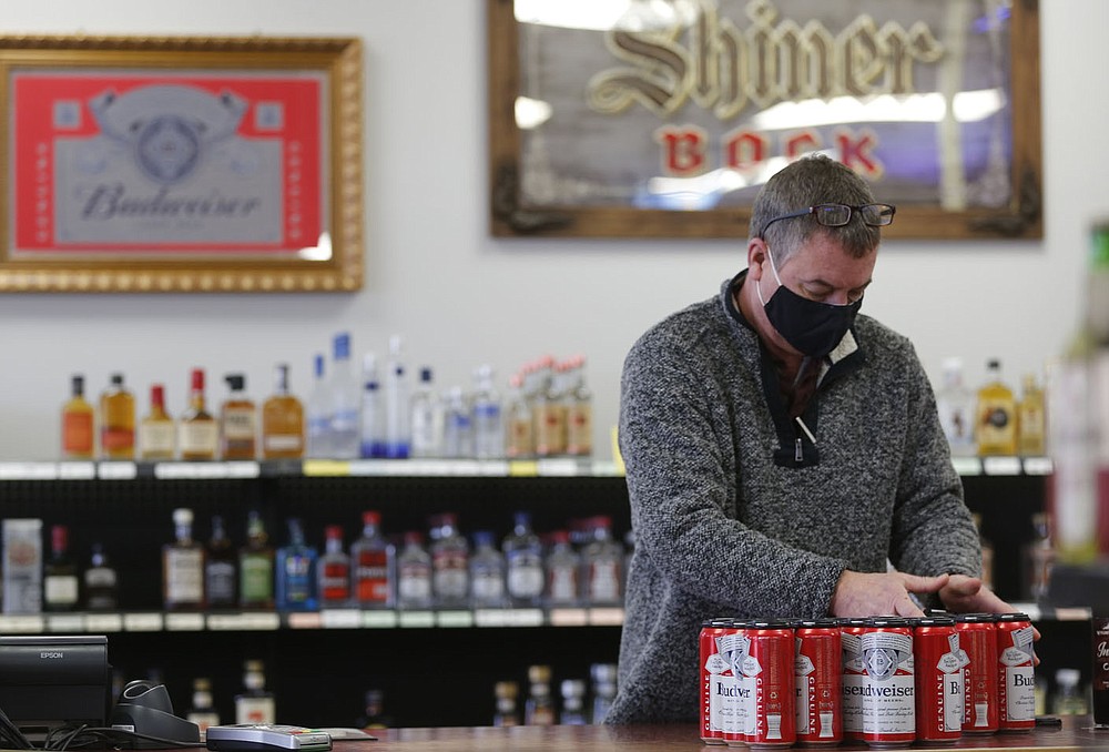 Charles Jech builds Tuesday, January 26, 2021, six packs of beer inside C and J Liquor located at 129 Fowler St., Suite A in Gentry. A special election on Feb. 9 will determine whether to authorize the sale of alcoholic beverages for off-premises consumption on Sundays between the hours of 10 a.m. and midnight within the city of Gentry. The City Council on Sept. 8 voted to add the ballot initiative to the Nov. 3 general election following a petition by Charles and Jerah Jech to have the initiative added to the ballot. The measure was submitted too late for the Nov. 3 ballot and was moved to December. When that wouldn’t work, the election was scheduled for Feb. 9. Check out nwadg.com/photos for a photo gallery.
(NWA Democrat-Gazette/David Gottschalk)