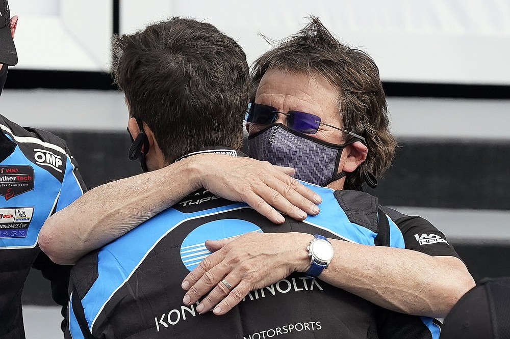 Team owner Wayne Taylor, right, hugs his son Ricky after winning the Rolex 24 hour auto race at Daytona International Speedway, Sunday, Jan. 31, 2021, in Daytona Beach, Fla. (AP Photo/John Raoux)