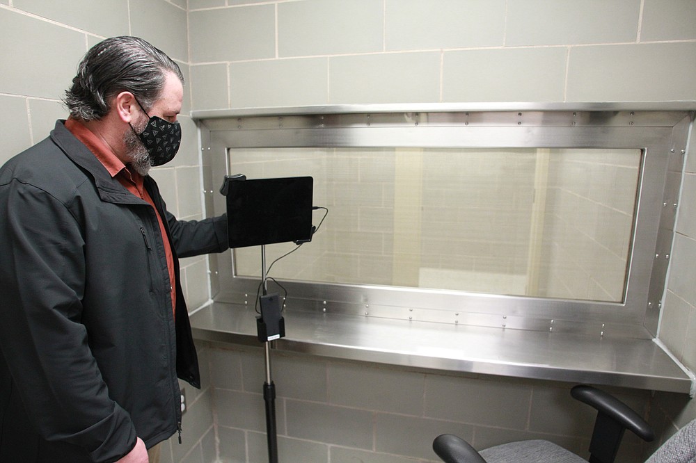Chief Deputy U.S. Marshal Jay Tuck, currently the acting U.S. marshal for the Eastern District of Arkansas, stands in a holding area where federal prisoners transported to the federal courthouse in Little Rock can meet with their attorneys and a tablet makes it possible for them to appear in court via a video conference link. The tablet is supplied by the court clerk's office which also provides technical assistance. (Arkansas Democrat-Gazette/Dale Ellis)
