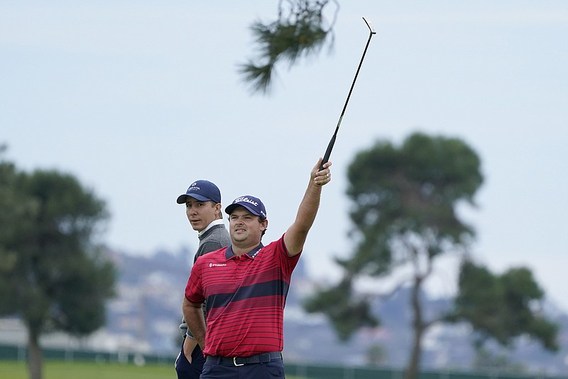 Patrick Reed, right, signals for an official in front of Carlos Ortiz, of Mexico, on the 16th hole on the South Course during the final round of the Farmers Insurance Open golf tournament at Torrey Pines, Sunday, Jan. 31, 2021, in San Diego. (AP Photo/Gregory Bull)