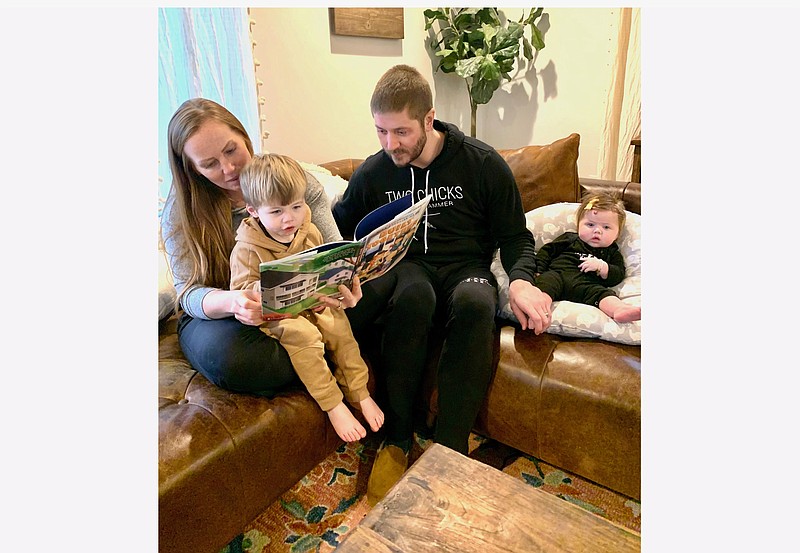 HGTV’s “Good Bones” star Mina Starsiak-Hawk with her husband, Steve, reads her new children’s book to son, Jack, 2, as daughter, Charlie, four-months, listens in. (Courtesy of Starsiak-Hawk)