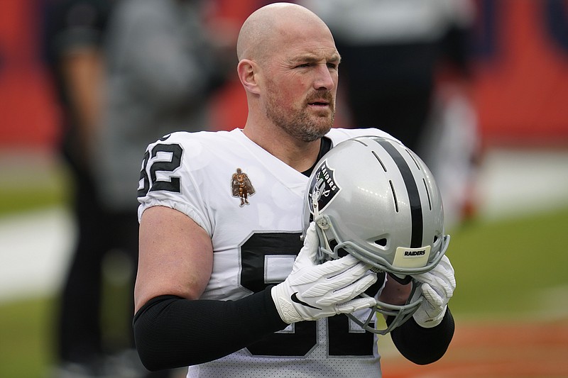 FILE - In this Jan. 3, 2021, file photo, Las Vegas Raiders tight end Jason Witten warms up for the team's NFL football game against the Denver Broncos in Denver. Witten says he is retiring again, apparently for good this time. The longtime Dallas Cowboys tight end who spent his final season with the Raiders told ESPN on Wednesday, Jan. 27, that he was walking away “knowing that for 17 seasons I gave it my absolute all.” (AP Photo/David Zalubowski, File)