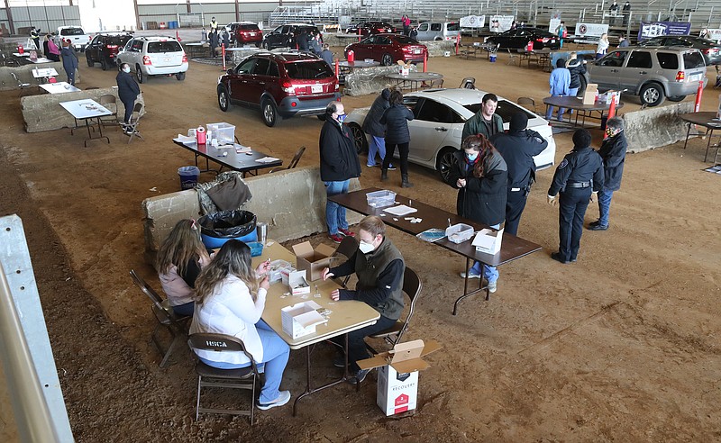 Volunteers give vaccinations Tuesday, Feb. 2, during a COVID-19 vaccination clinic at the Garland County Fairgrounds. - Photo by Richard Rasmussen of The Sentinel-Record