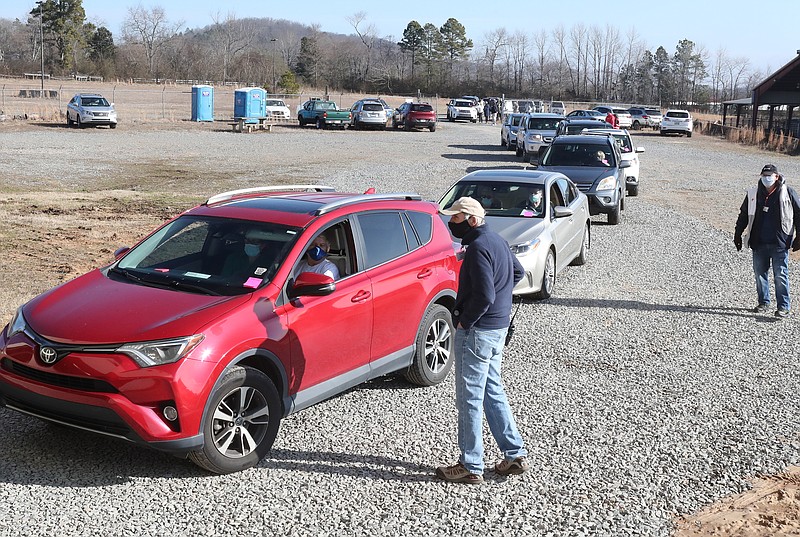 Cars wait in line Tuesday, Feb. 2,lat to enter the COVID-19 vaccination clinic at the Garland County Fairgrounds. - Photo by Richard Rasmussen of The Sentinel-Record