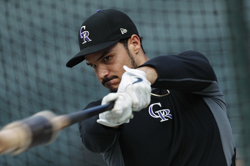 FILE - In this Friday, Sept. 27, 2019, file photo, Colorado Rockies third baseman Nolan Arenado warms up before a baseball game against the Milwaukee Brewers in Denver. Team owner Dick Monfort and general manager Jeff Bridich will hold a zoom press conference Tuesday, Feb. 2, 2021, to discuss the trade of the team's star third baseman, Nolan Arenado, to the St. Louis Cardinals. (AP Photo/David Zalubowski, File)